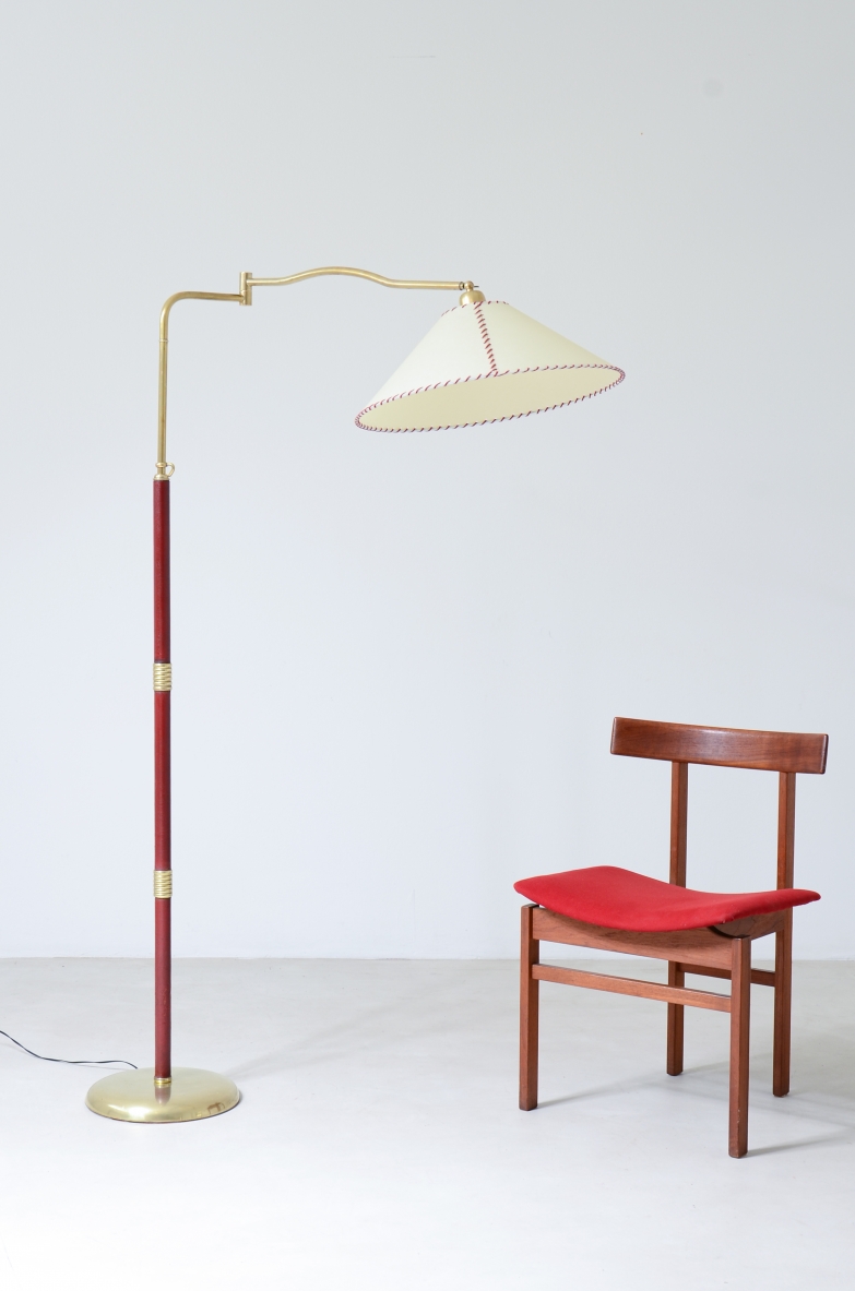Floor lamp with adjustable brass stem and leather details, elegant parchment lampshade.  Italian manufacture 1930's.