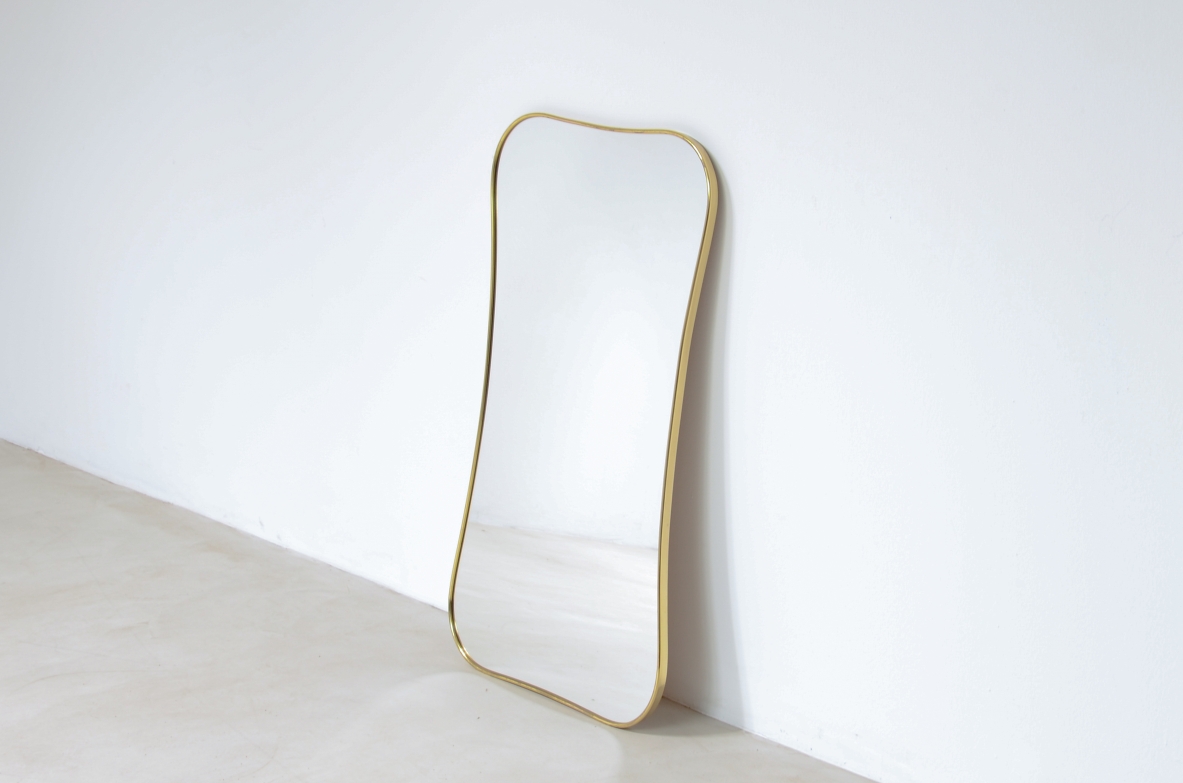 Mirror with shaped brass frame.  Italian 1950s/60s manufacturing.