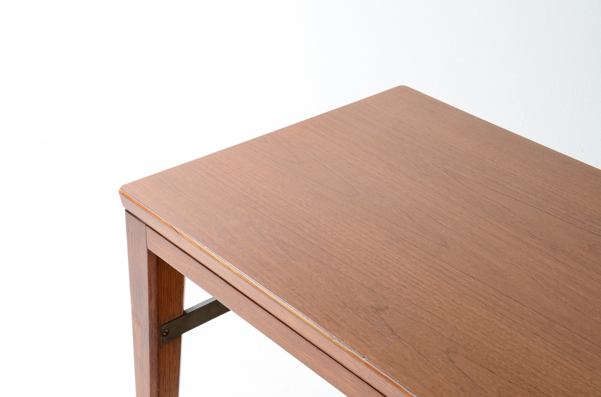 Gio Ponti  Elegant oak desk designed by Gio Ponti for the National bank. Slightly curved legs joined by a brass spacer, three drawers with shaped front.