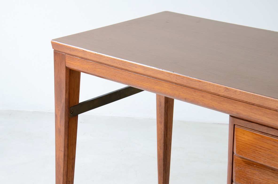 Gio Ponti Elegant oak desk designed by Gio Ponti for the National bank. Slightly curved legs joined by a brass spacer, three drawers with shaped front.