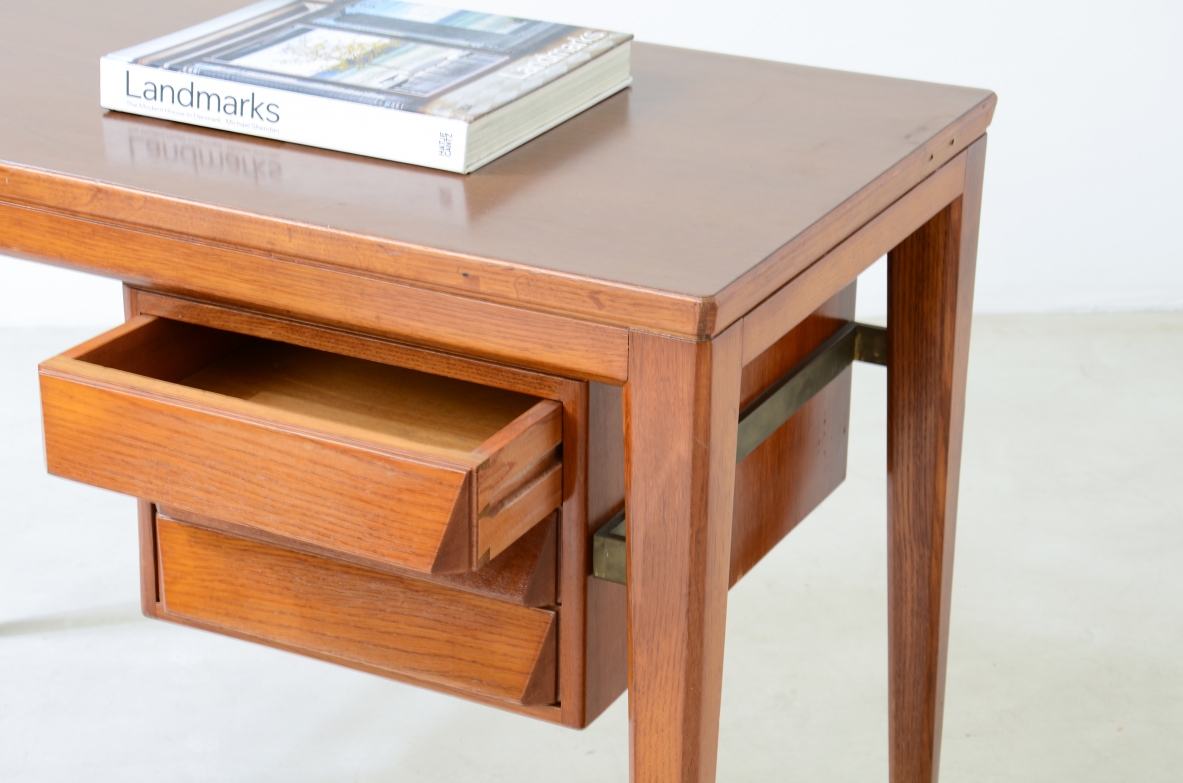 Gio Ponti  Elegant oak desk designed by Gio Ponti for the National bank. Slightly curved legs joined by a brass spacer, three drawers with shaped front.