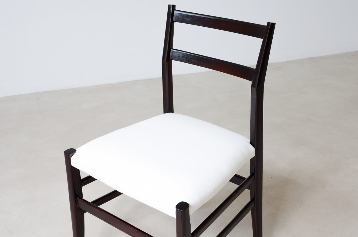 Gio Ponti  Set of 12 chairs in black stained wood with fabric covering.  Modello leggera,  Cassina manufacture 1954.