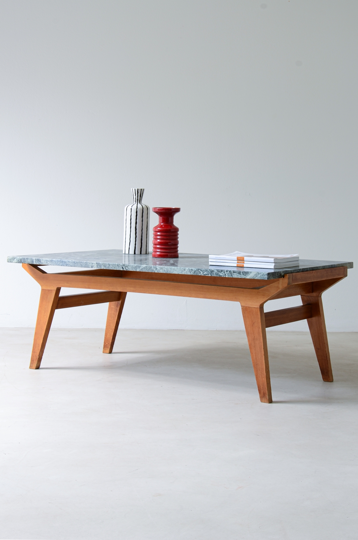 Ico Parisi Shaped wooden living room table with green Alps marble top.