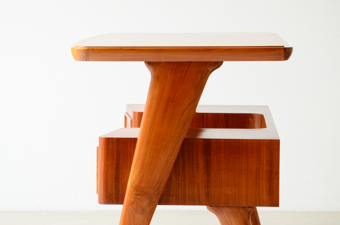 Small walnut desk with two drawers and storage compartment.1950