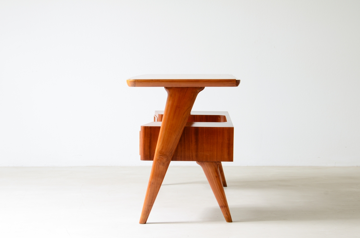 Small walnut desk with two drawers and storage compartment.1950