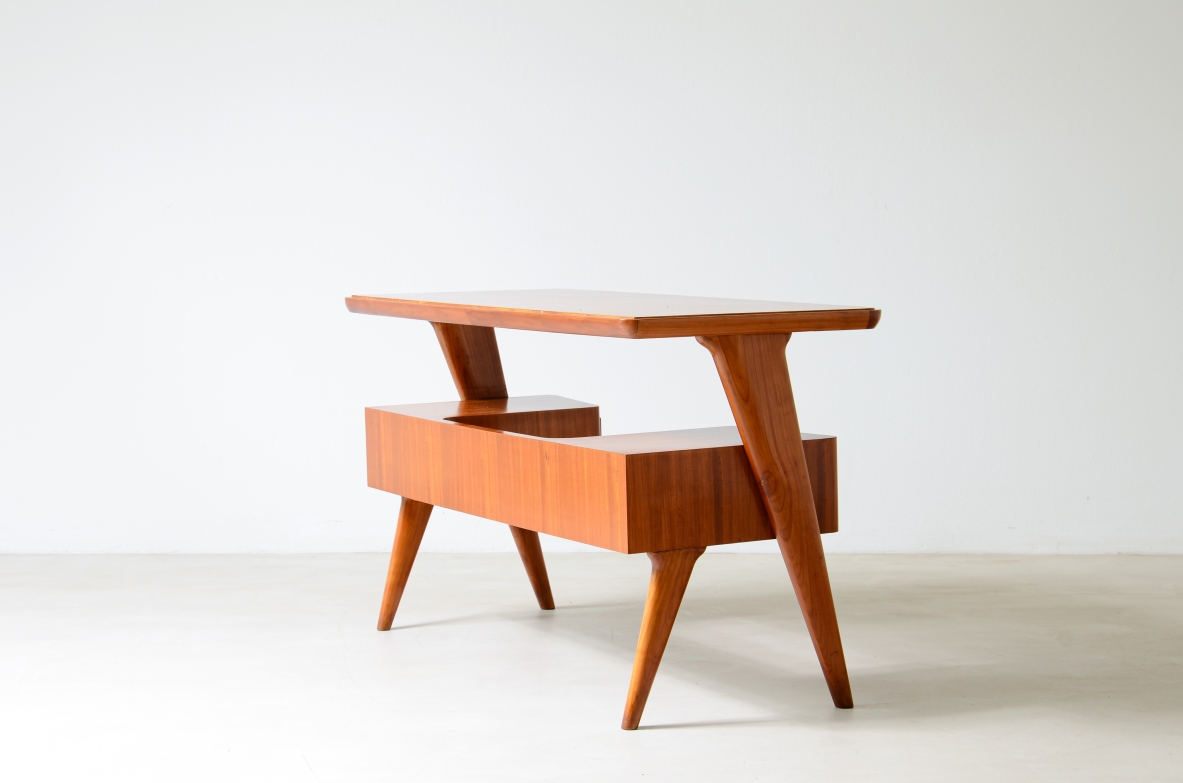 Small walnut desk with two drawers and storage compartment.1950