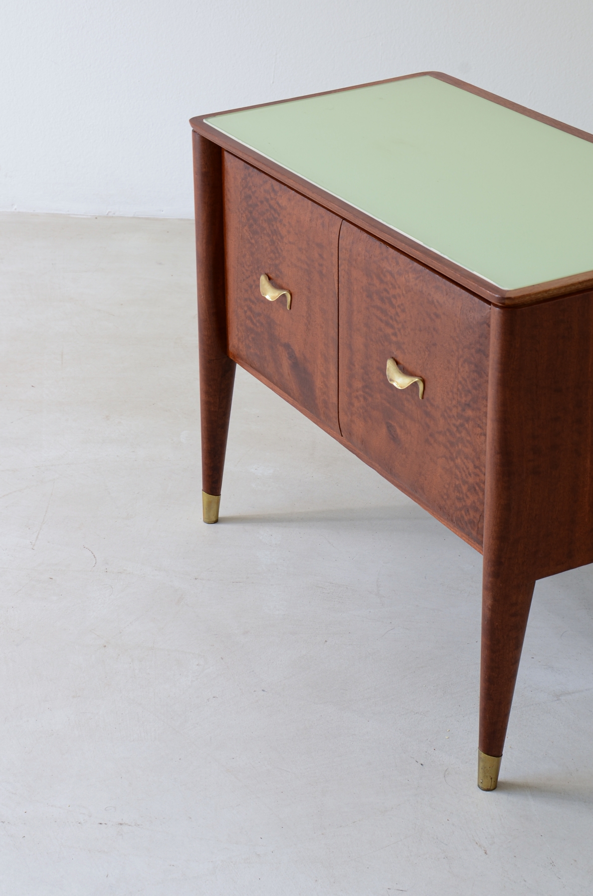 Pair of bedside tables with tapered legs, brass tips and handles 1950's