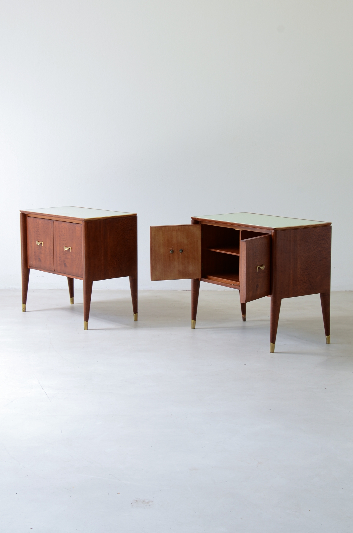 Pair of bedside tables with tapered legs, brass tips and handles 1950's