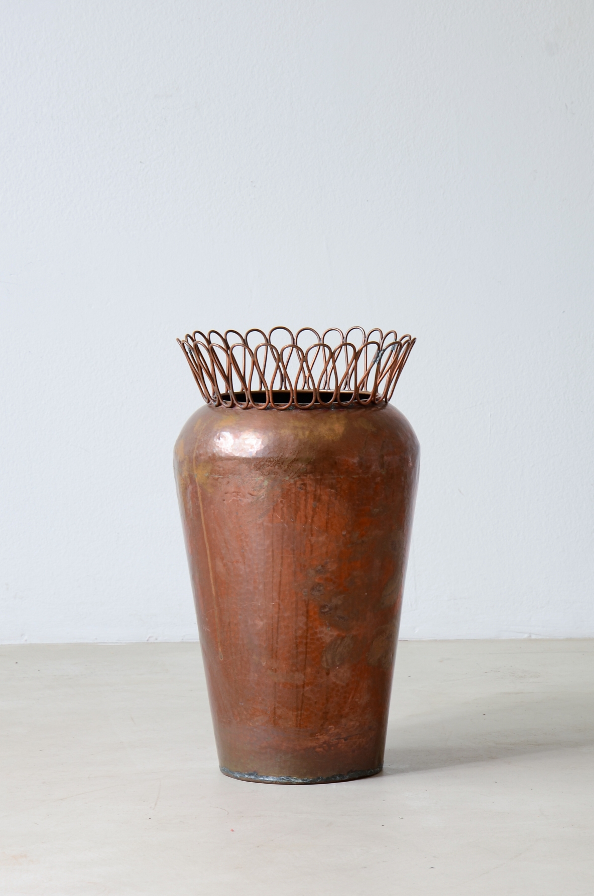 Gio Ponti  Turned copper umbrella stand with continuous ribbon crown.
