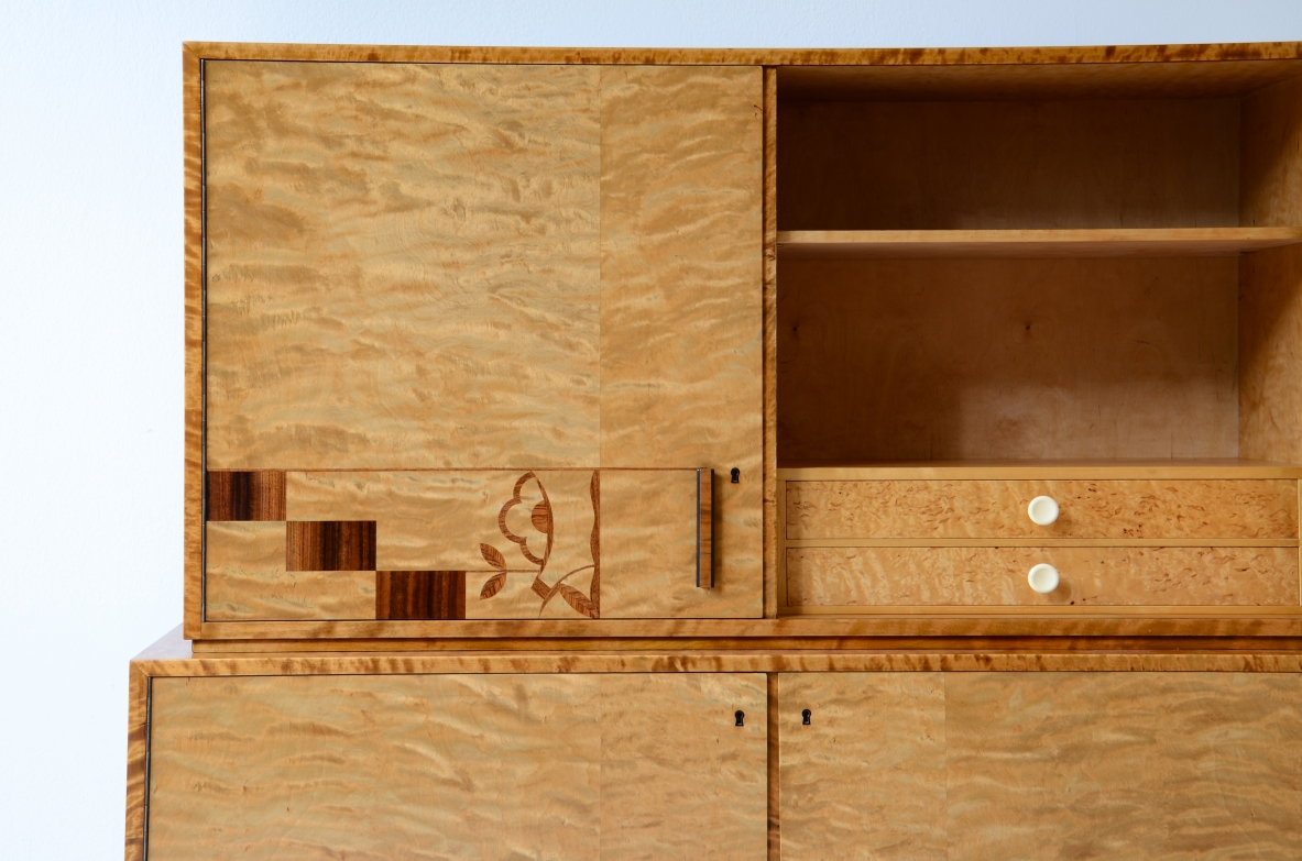 Storage unit in the style of Axel Einar Hjort, in flamed maple with Art Deco inlays on the front.  Sweden  approx. 1930