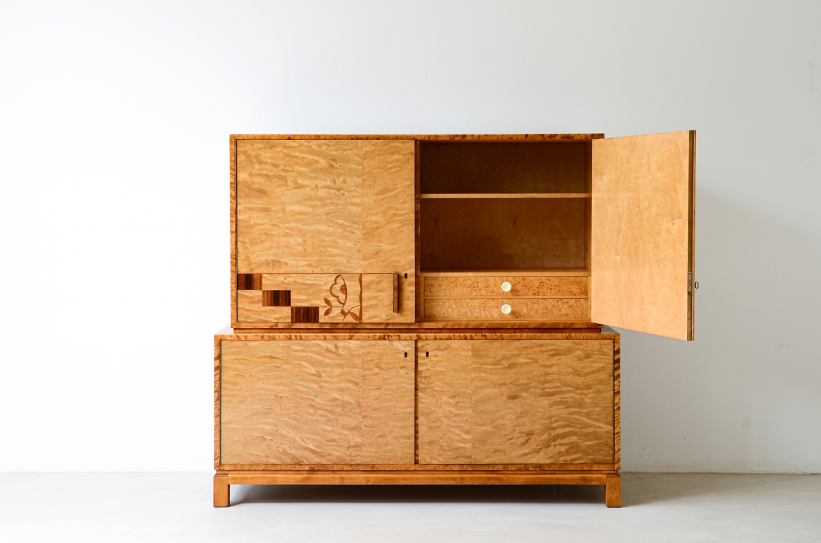 Storage unit in the style of Axel Einar Hjort, in flamed maple with Art Deco inlays on the front.  Sweden  approx. 1930