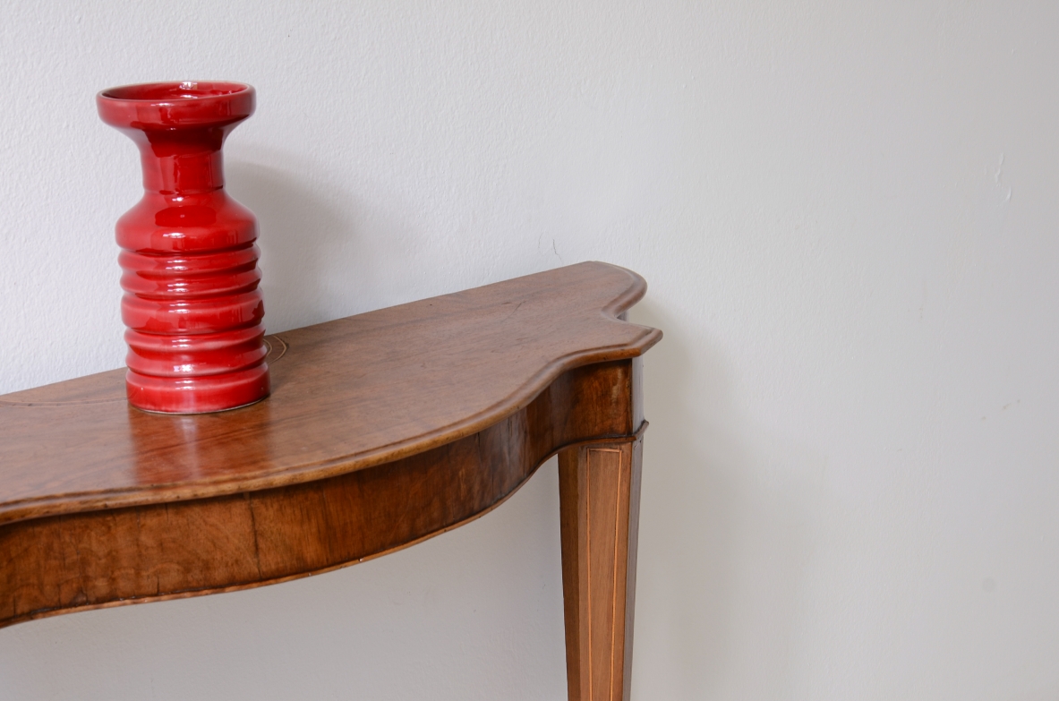 Small console in walnut with shaped top and thin tapered legs.1850