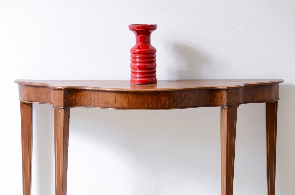 Small console in walnut with shaped top and thin tapered legs.1850