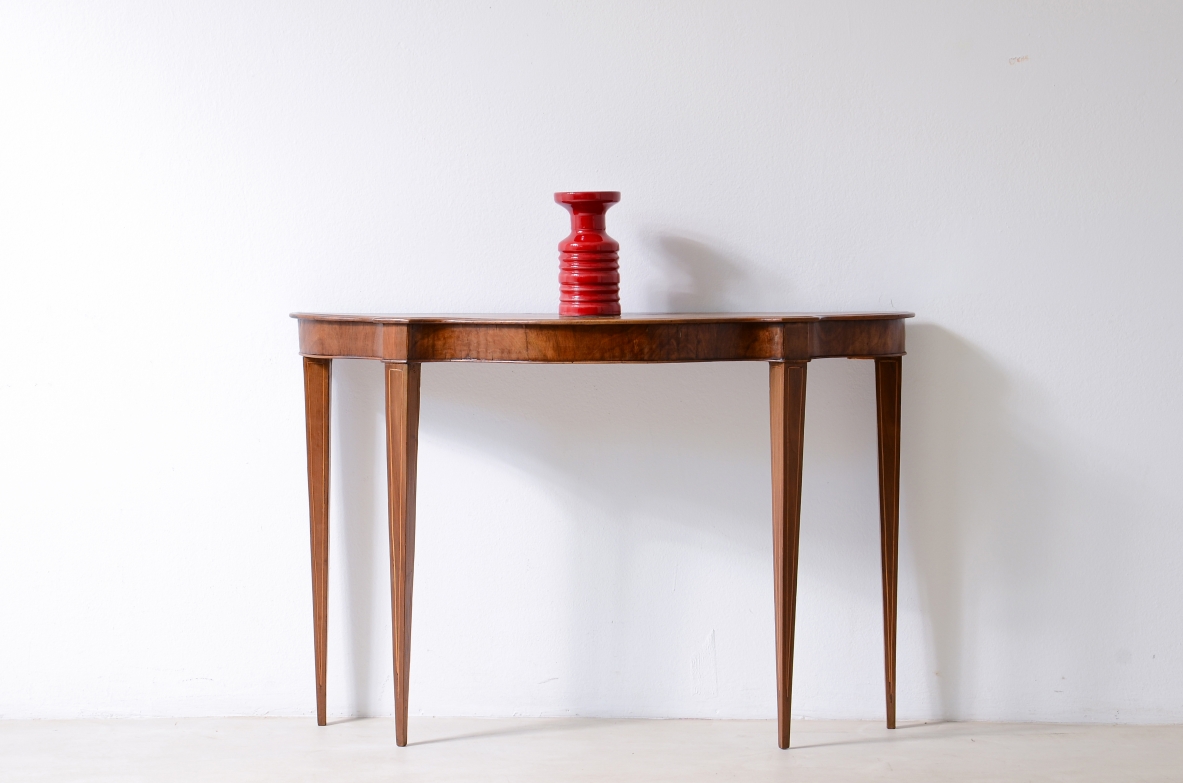 Small console in walnut with shaped top and thin tapered legs.1780