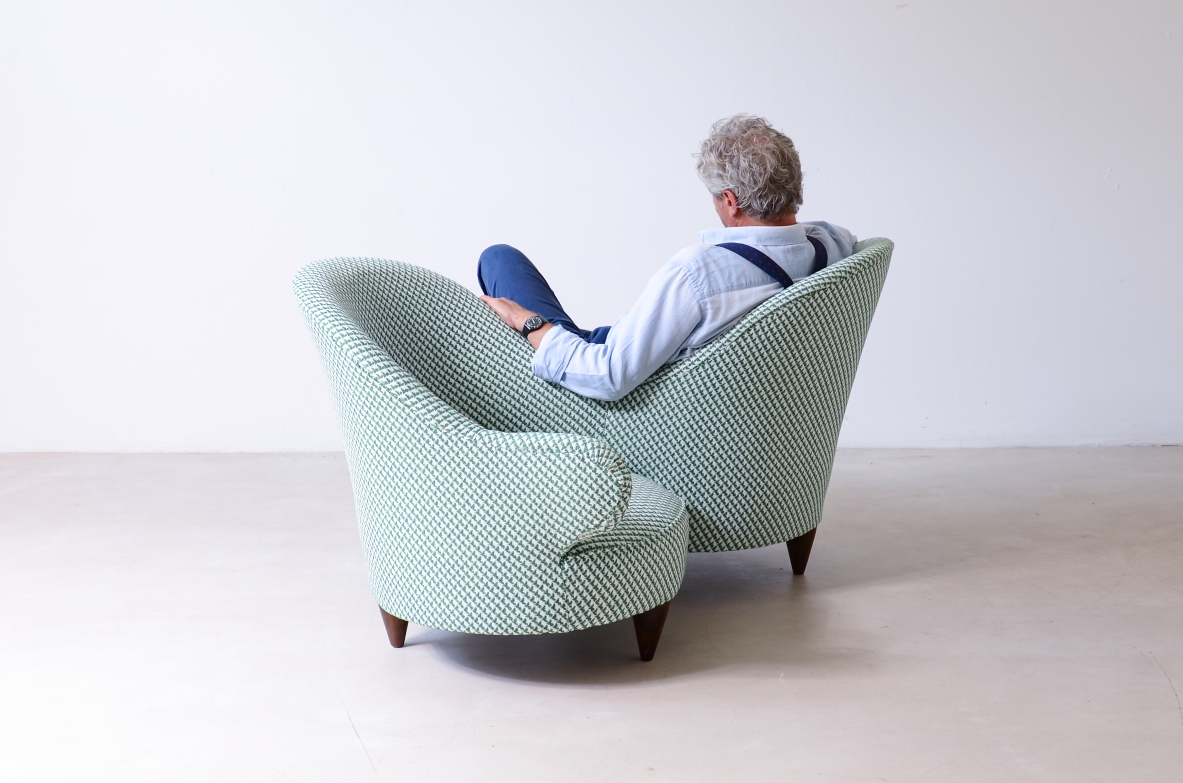 Conversation sofa for two, upholstered in padded fabric.  Italian manufacture, ca.1950.