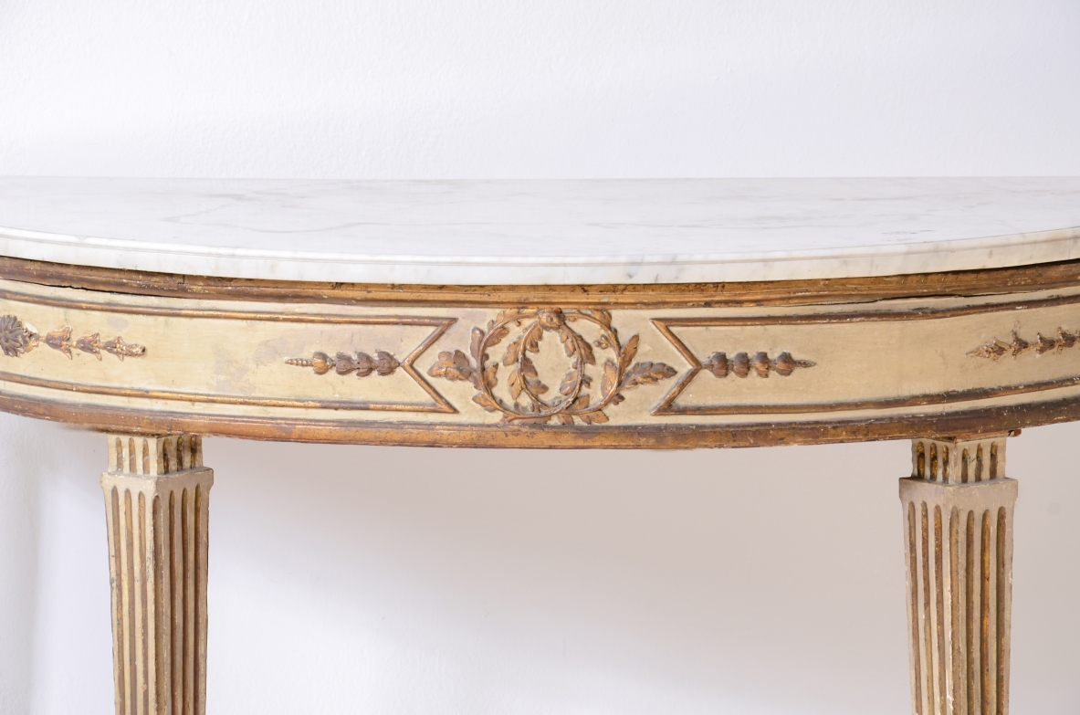 Pair of elegant half-moon console tables in lacquered and gilded wood, Louis XVI period, ca. 1770.