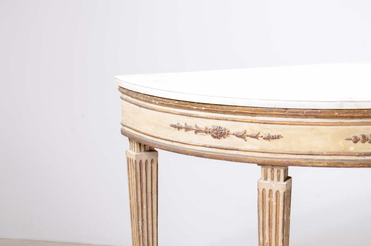 Pair of elegant half-moon console tables in lacquered and gilded wood, Louis XVI period, ca. 1770.