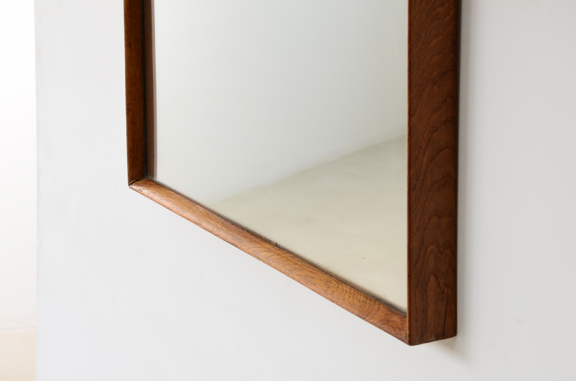 Two mirrors with shaped wooden frames.