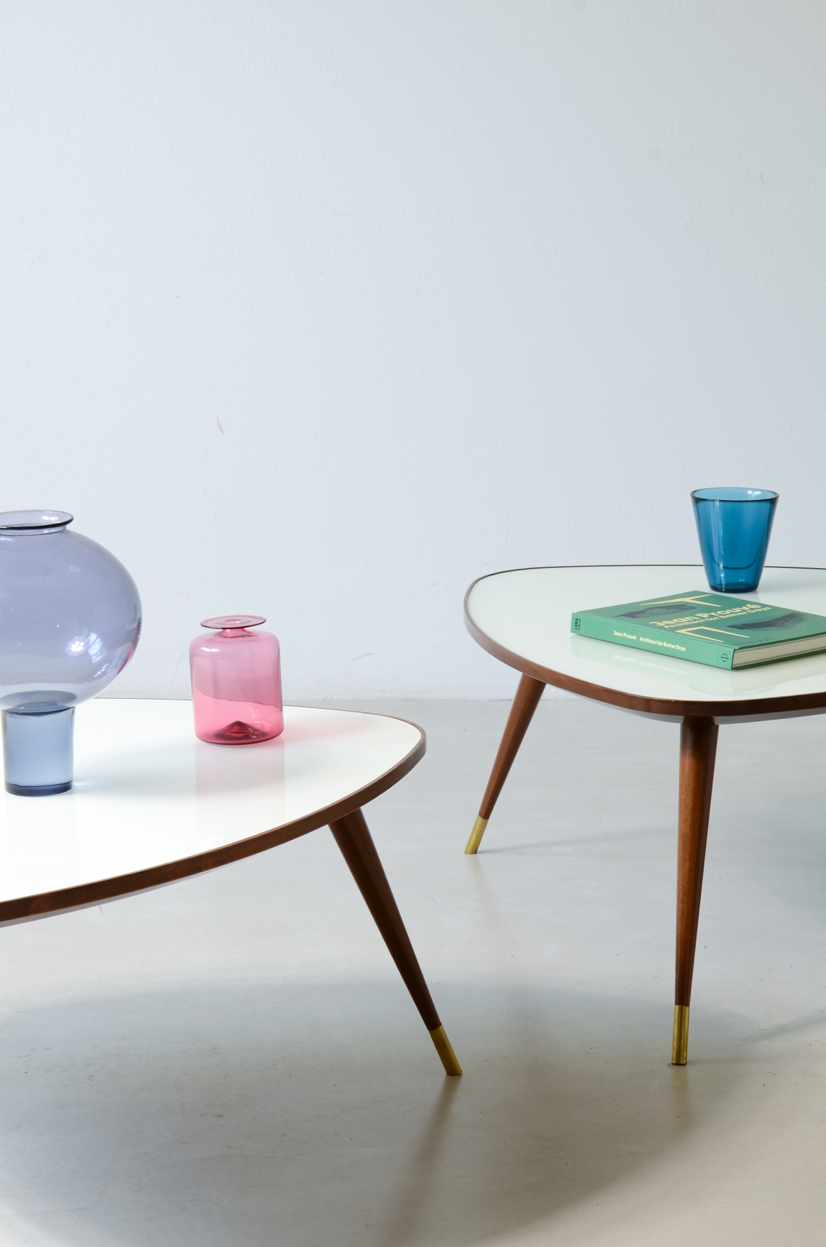 Osvaldo Borsani  Pair of elegant coffee tables with a beveled glass top. Reissue by Officina Antiquaria