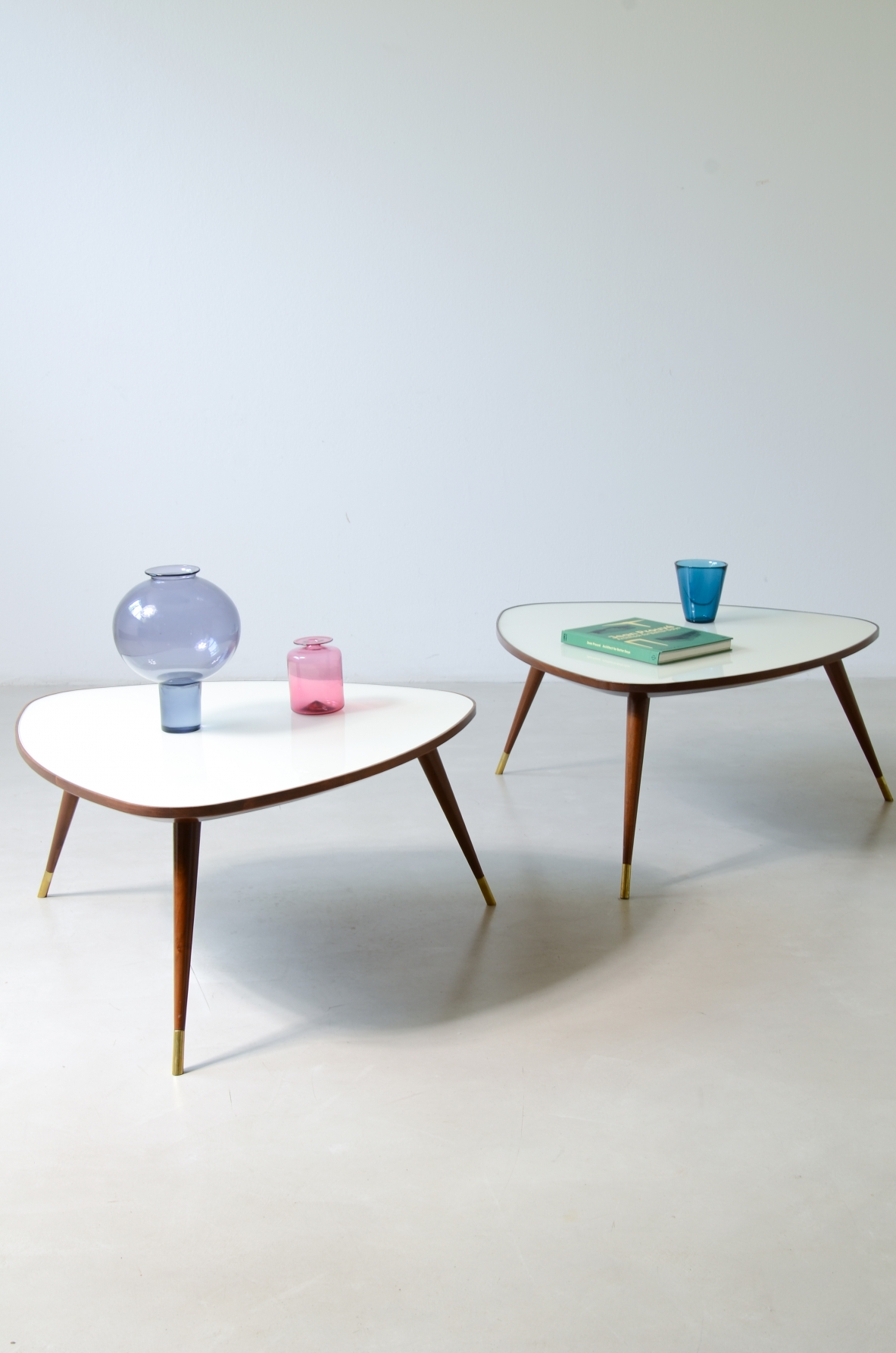 Osvaldo Borsani  Pair of elegant coffee tables with a beveled glass top. Reissue by Officina Antiquaria