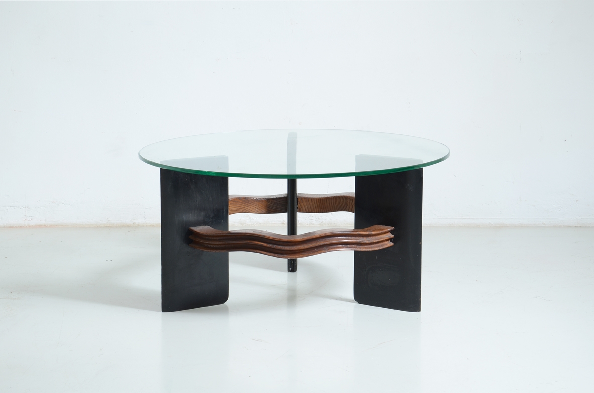 Elegant table with support in wood and aniline-stained wood and glass top.