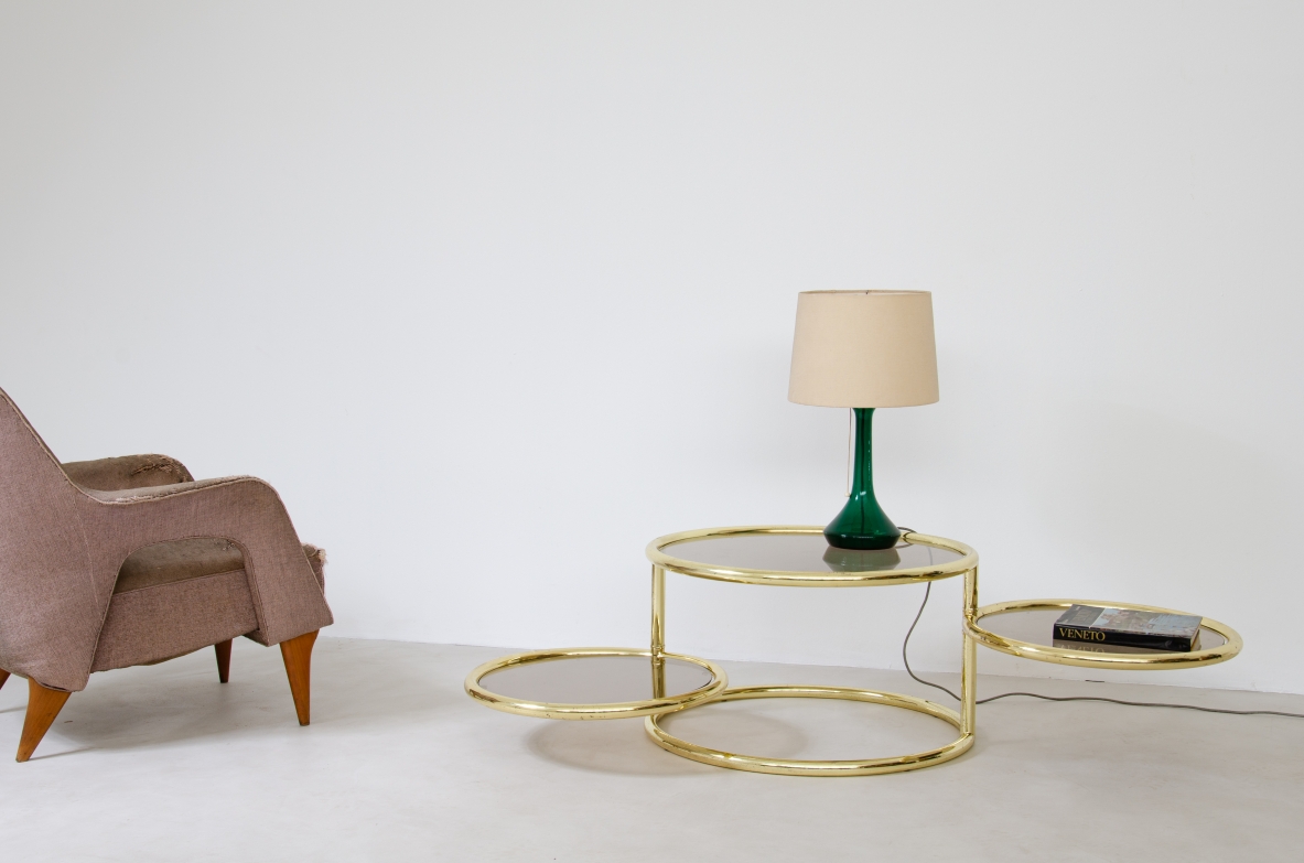 Coffee table in brass with rotating elements and original glass top. Italy 1970's.