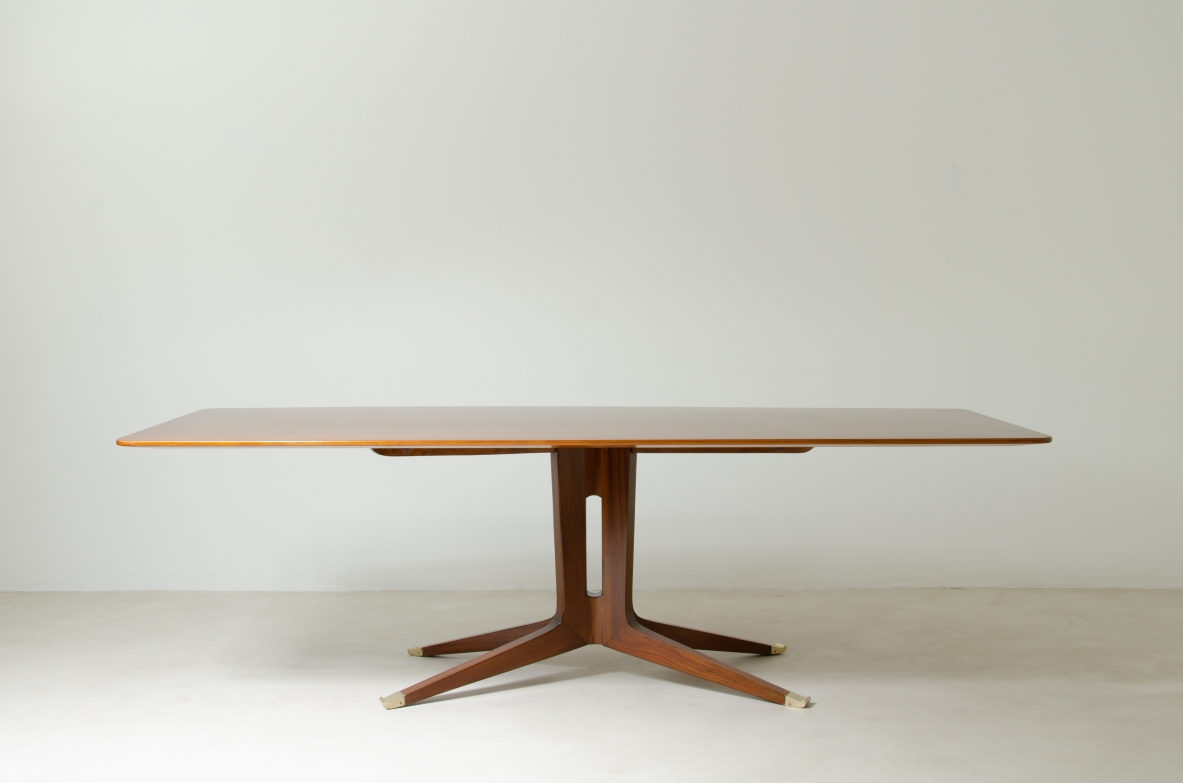 Large mahogany table with shaped top and leg with central stem and four spokes with elegant brass tip.  1950's Italian manufacture.