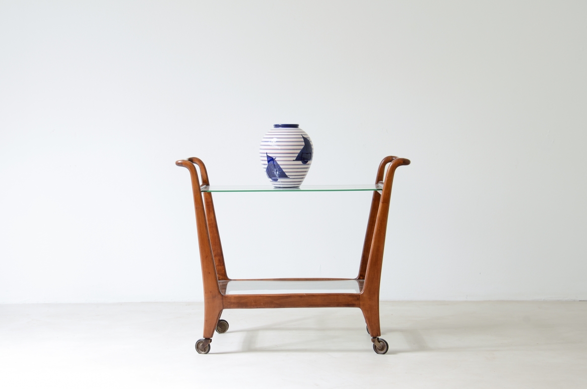Walnut wood trolley with glass tops and wheels in the style of Gio Ponti.  Italy, 1950